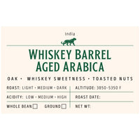 Whiskey barrel aged coffee whole beans close-up – oak infused Arabica